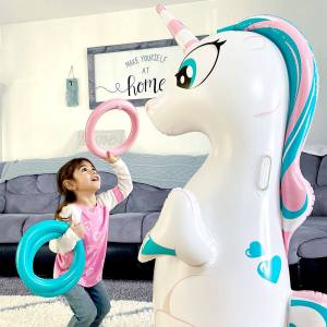 Girl reaching for the Inflatable Unicorn Ring Toss Kids Toy